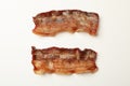 Tasty fried bacon slices on white background Royalty Free Stock Photo