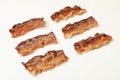 Tasty fried bacon slices on white background Royalty Free Stock Photo