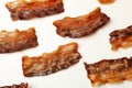 Tasty fried bacon slices on white background Royalty Free Stock Photo