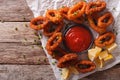 Tasty Fried calamari rings close-up on a table, and tomato sauce Royalty Free Stock Photo