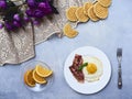 Tastu fried egg in plate with bacon Royalty Free Stock Photo