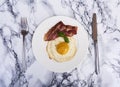 Tastu fried egg in plate with bacon Royalty Free Stock Photo