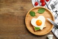 Tasty fried egg in shape of heart with toast served on wooden table, flat lay. Space for text Royalty Free Stock Photo