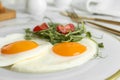 Tasty fried eggs with tomato and sprouts on plate Royalty Free Stock Photo