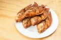 Tasty fried fish, tilapia on a white plate; photo on wooden background Royalty Free Stock Photo