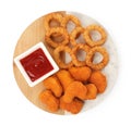 Tasty fried onion rings, chicken nuggets and ketchup isolated on white, top view Royalty Free Stock Photo