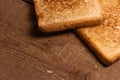 Tasty fried toast bread slices lie on a natural wooden background Royalty Free Stock Photo