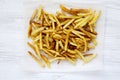 Tasty fries on white wooden background, top view, close up. Flat Royalty Free Stock Photo