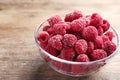 Tasty frozen raspberries on wooden table, closeup Royalty Free Stock Photo