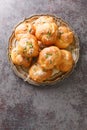 Tasty Garlic knots buns with Parmesan cheese and dried greens closeup on the plate. Vertical top view Royalty Free Stock Photo