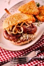 Tasty German bratwurst burger with onion rings Royalty Free Stock Photo