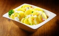 Tasty german Potato salad with Herbs and Spices on Bowl