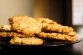Tasty glossy brown oatmeal cookies on black plate Royalty Free Stock Photo