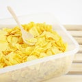 The tasty golden corn flakes in plastic container box