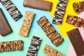 Tasty granola bars on multicolor background top view