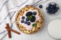 Tasty granola, yogurt and fresh berries in bowl on white tiled table, flat lay. Healthy breakfast Royalty Free Stock Photo