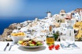 Tasty Greek food with salad, fried potatoes and fresh olive oil