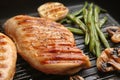 Tasty grilled chicken fillets and vegetables on frying pan, closeup Royalty Free Stock Photo