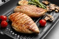 Tasty grilled chicken fillets and vegetables on frying pan, closeup Royalty Free Stock Photo
