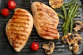 Tasty grilled chicken fillets and vegetables on frying pan, flat lay Royalty Free Stock Photo