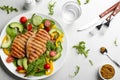 Tasty grilled chicken fillets with vegetables served on light grey table, flat lay Royalty Free Stock Photo