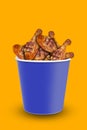 Tasty grilled chicken pieces on orange background , closeup. chicken bucket. Space for text