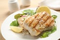 Tasty grilled fish with lemon served on table Royalty Free Stock Photo