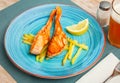 Tasty grilled salmon served with french fries Royalty Free Stock Photo