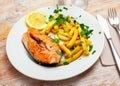 Tasty grilled salmon served with french fries Royalty Free Stock Photo