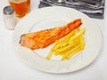 Tasty grilled salmon served with french fries Royalty Free Stock Photo