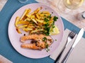 Tasty grilled salmon served with french fries Royalty Free Stock Photo