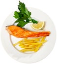 Tasty grilled salmon served with french fries Royalty Free Stock Photo