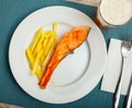 Tasty grilled salmon served with french fries Royalty Free Stock Photo