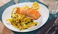 Tasty grilled salmon served with french fries Royalty Free Stock Photo