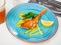 Tasty grilled salmon served with french fries Royalty Free Stock Photo