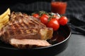 Tasty grilled steak served on black table, closeup Royalty Free Stock Photo