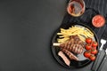 Tasty grilled steak served on black table, flat lay. Space for text Royalty Free Stock Photo
