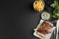 Tasty grilled steak served on black table, flat lay. Space for text Royalty Free Stock Photo