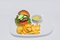 Tasty hamburger, French fries and chili sauce on white plate, Fast food with copy space Royalty Free Stock Photo