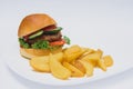 Tasty hamburger, French fries and chili sauce on white plate, Fast food with copy space Royalty Free Stock Photo