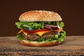 Tasty hamburger on wood background