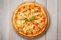 Tasty hawaiian pizza with chicken and pineapple on wooden cutting board. Top view Royalty Free Stock Photo