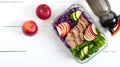 Tasty healthy lunch of vegetables, baked turkey and a bottle of water. Salad of red cabbage, spinach, apples, fresh cucumbers with Royalty Free Stock Photo