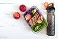 Tasty healthy lunch of vegetables, baked turkey and a bottle of water. Salad of red cabbage, spinach, apples, fresh cucumbers with Royalty Free Stock Photo