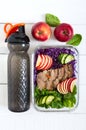 Tasty healthy lunch of vegetables, baked turkey and a bottle of water. Salad of red cabbage, spinach, apples, fresh cucumbers with Royalty Free Stock Photo