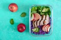 Tasty healthy lunch of vegetables and baked turkey. Salad of red cabbage, spinach, apples, fresh cucumbers with diet meat in a Royalty Free Stock Photo