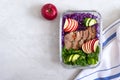 Tasty healthy lunch of vegetables and baked turkey. Salad of red cabbage, spinach, apples, fresh cucumbers with diet meat in a Royalty Free Stock Photo