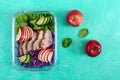 Tasty healthy lunch of vegetables and baked turkey. Salad of red cabbage, spinach, apples, fresh cucumbers with diet meat in a Royalty Free Stock Photo