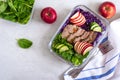 Tasty healthy lunch of vegetables and baked turkey. Salad of red cabbage, spinach, apples, fresh cucumbers with diet meat in a Royalty Free Stock Photo