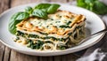 Tasty healthy portion of vegetarian spinach lasagne with tofu and pesto Royalty Free Stock Photo